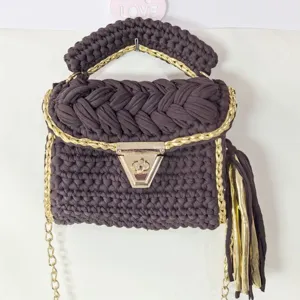 Handcrafted dark brown crochet handbag with metallic gold chain details and side tassel.