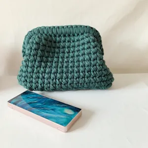 Dark green handmade crochet clutch bag, trendy frame pouch with soft t-shirt yarn texture.
