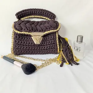 Handmade crochet handbag with metallic gold chain and lock, stylish dark brown knit purse.