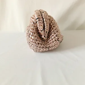 Metallic iridescent handmade crochet clutch bag, detailed view of woven pouch design.