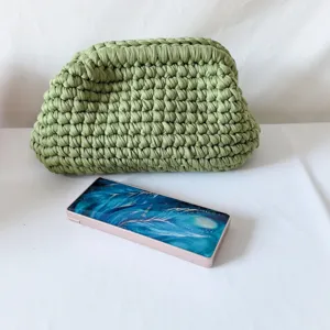 Handcrafted green crochet clutch bag, chic woven pouch design with frame closure for women.