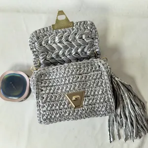 Silver handmade crochet shoulder bag crafted with metallic yarn, chic tassel and lock.