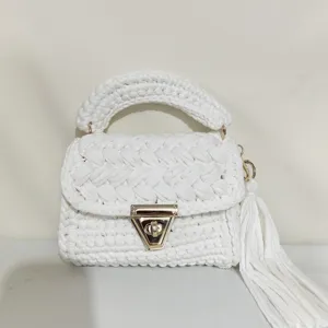 Handmade white crochet bag detail showcasing the woven texture, gold lock, and stylish tassel.
