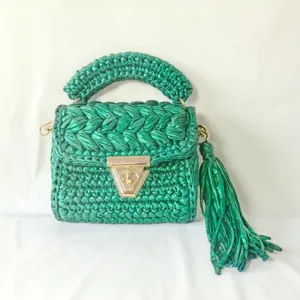 Detailed view of the handmade metallic green crochet mini square bag with elegant gold hardware clasp.