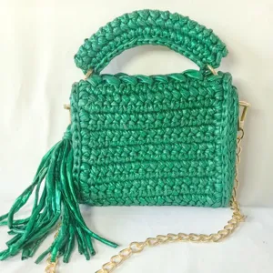Handmade metallic crochet women shoulder bag featuring chic chain strap and a tassel accent.