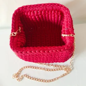 Handmade red fabric crochet shoulder bag detail, stylish gold chain strap for women.