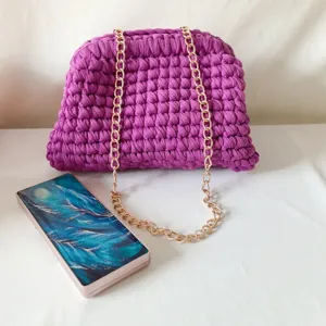 Handmade crochet shoulder bag in vibrant purple with elegant gold chain strap for women.