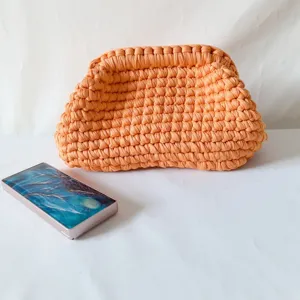 Handmade crochet fabric clutch bag for women, stylish orange woven pouch purse for daily use.