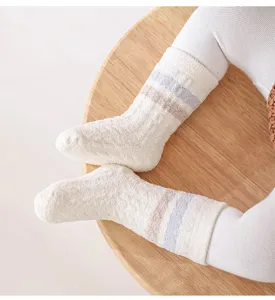 Infant thick warm winter socks detail view, soft cozy fluffy material with cute stripes.