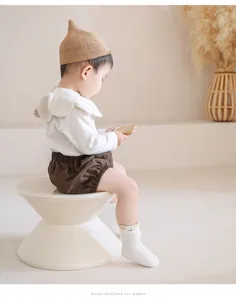 Bambino che indossa graziosi calzini in cotone con orecchie di animale in un bel studio.