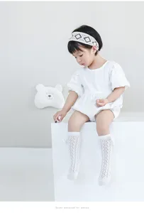 Detail view of breathable baby girl lace knee-high socks with cute bow, perfect for summer.