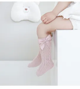 Cute baby girl summer breathable hollow-out bow knee-high socks in soft pink color.