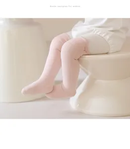 Infant cotton high tube socks detail, soft pink wide cuff design for baby spring wear.