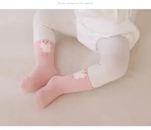 Detail view of cute pink cotton baby socks with adorable bunny pattern, soft and comfortable.