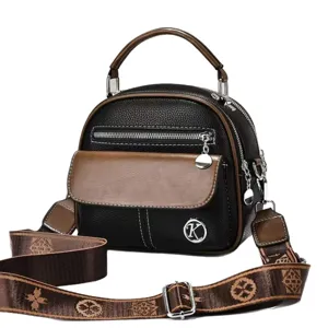 Retro black brown dome handbag with top handle and patterned crossbody strap for women.