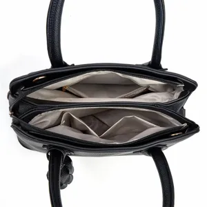 Detailed top view of black leather women handbag interior compartments and lining features.