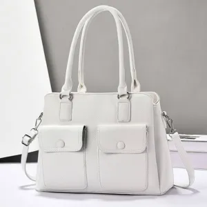White PU leather tote bag detail showcasing dual front flap pockets and sturdy top handles.