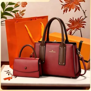 Details of luxury women handbag set with structured burgundy tote and matching crossbody bag.