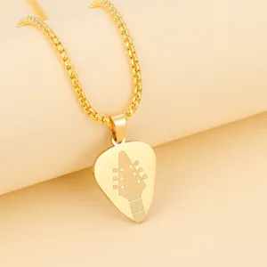 Gold stainless steel guitar pick pendant necklace, detailed engraved music jewelry close-up.