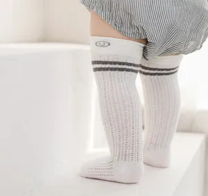 Close-up detail of breathable mesh baby knee-high socks, soft non-binding elastic top.