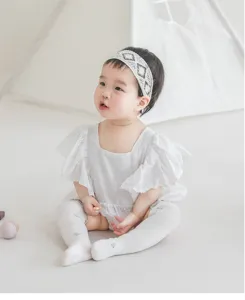 Close-up detail of breathable mesh baby knee-high socks worn by an infant in studio.