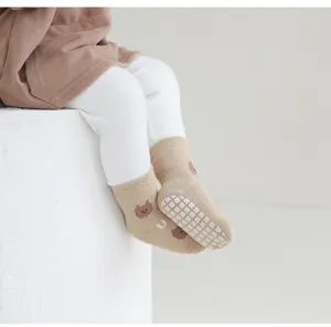 Cute baby floor socks with anti-slip grips, cozy mid-tube toddler knit socks for indoor wear.