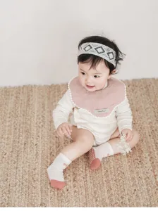 Detailed shot of baby non-slip floor socks with cute stripes, soft infant wear setting.
