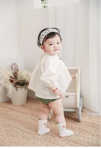 Cute newborn baby socks with sweet strawberry embroidery, soft seamless design for infants.