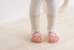 Close-up detail of thickened baby winter socks with cute cartoon pattern and warm fit.