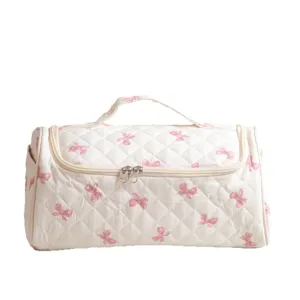 Quilted travel makeup bag with cute pink bow print, large capacity portable toiletry organizer.