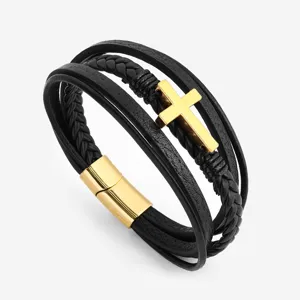 Close-up of men's multi-layer black leather bracelet with a gold cross and magnetic clasp.
