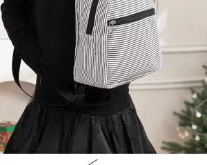 Black and white striped seersucker backpack detail, lightweight casual daypack for women.