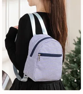 Stylish striped mini backpack for women, casual seersucker school bag with zipper pockets.