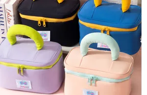 Close-up view of large capacity waterproof marshmallow cosmetic bags with colorful handles.