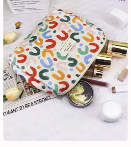 Quilted cosmetic bag with colorful print, large capacity portable toiletry pouch for daily use.