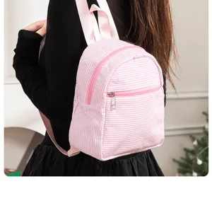 Pink white striped seersucker mini backpack detail view, casual lightweight daypack.
