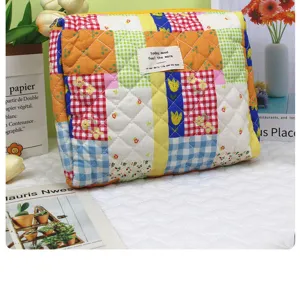 Large capacity quilted cosmetic bag floral patchwork makeup pouch for travel and daily use.