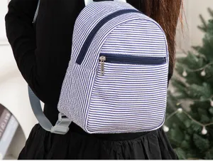 Stylish blue and white striped seersucker mini backpack for women casual daily use.
