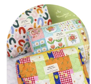 Quilted cosmetic bag detail view, showing colorful patchwork pattern, soft cotton storage pouch.