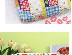 Quilted floral cosmetic bag detail, cotton storage pouch with patchwork design and vibrant print.