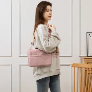 Detail view of pink 11-inch iPad sleeve with adjustable shoulder strap and front pocket.