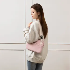 Detail view of the pink tablet shoulder bag featuring adjustable white strap and sleek design.