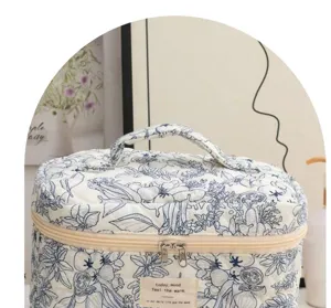 Quilted cosmetic bag with blue floral print, large capacity portable travel makeup organizer.
