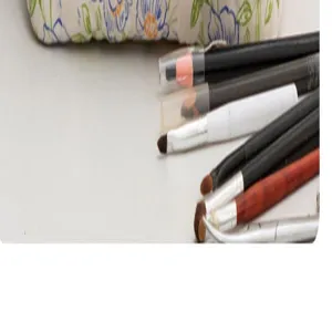 Floral quilted makeup bag detail showing soft fabric texture and cosmetic brush arrangement.