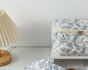 Quilted cotton cosmetic bag with blue floral print, portable makeup pouch storage.