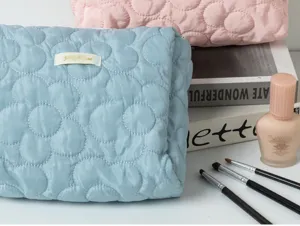 Quilted cosmetic bag with cute flower pattern, soft storage pouch for daily makeup essentials.