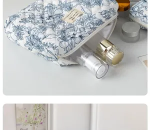 Cotton floral cosmetic bag detail view, quilted travel makeup pouch, portable storage bag.