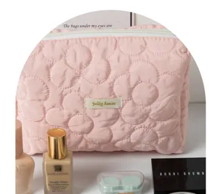 Pink floral quilted makeup bag detail view, stylish cosmetic pouch for travel and daily use.