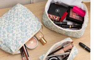 Cute floral quilted makeup bag for women, portable cotton cosmetic organizer pouch with zipper.