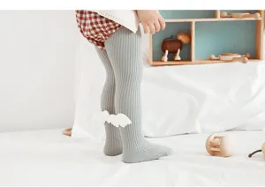 Detail view of cute baby toddler ribbed tights in grey featuring adorable 3d wings on back.